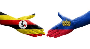Ellere boyanmış Lihtenştayn ve Uganda bayrakları arasındaki el sıkışma, izole şeffaf görüntü.