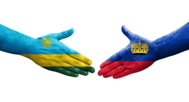 Lihtenştayn ve Ruanda bayrakları arasındaki el sıkışma ellerinde izole şeffaf görüntü.