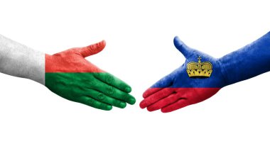 Lihtenştayn ve Madagaskar bayrakları arasındaki el sıkışma, izole şeffaf görüntü.