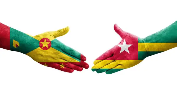 stock image Handshake between Grenada and Togo flags painted on hands, isolated transparent image.