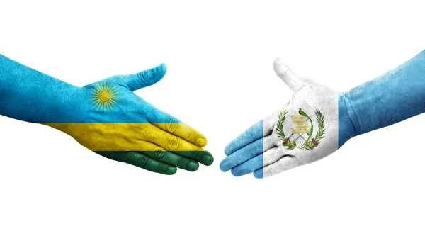 stock image Handshake between Guatemala and Rwanda flags painted on hands, isolated transparent image.