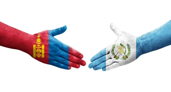 手に描かれたグアテマラとモンゴルの旗の間の握手 隔離された透明なイメージ — ストック写真