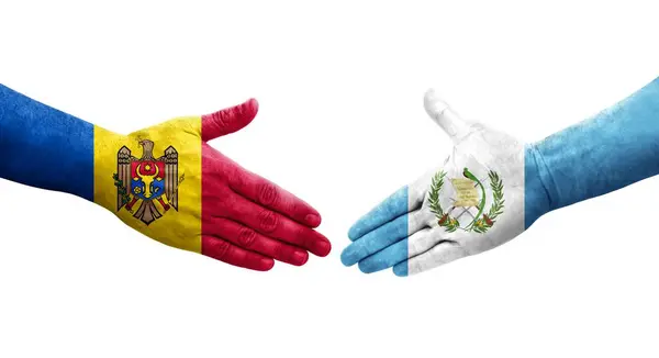 stock image Handshake between Guatemala and Moldova flags painted on hands, isolated transparent image.