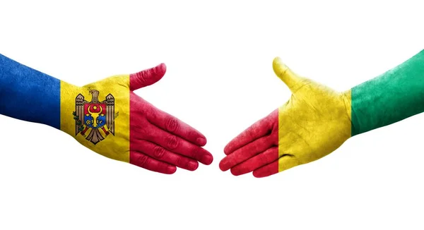 stock image Handshake between Guinea and Moldova flags painted on hands, isolated transparent image.