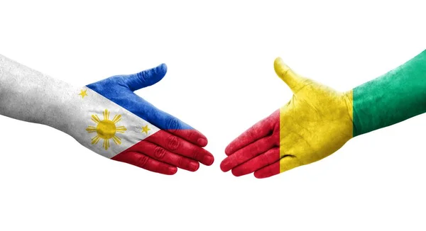 Uścisk Dłoni Między Gwineą Filipinami Flagi Malowane Rękach Odizolowany Przezroczysty — Zdjęcie stockowe