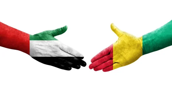 Handdruk Tussen Guinee Vae Vlaggen Geschilderd Handen Geïsoleerd Transparant Beeld — Stockfoto