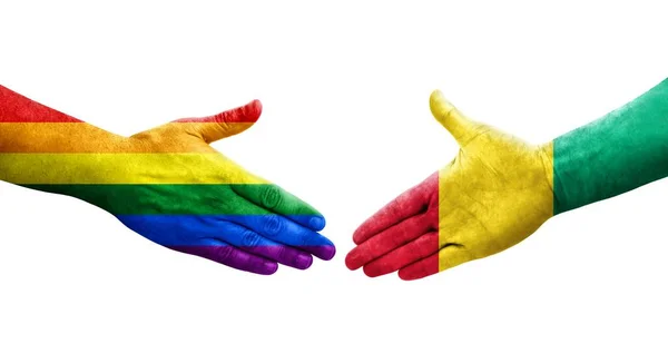 ギニアとLgbtの旗の間の握手手に描かれた孤立した透明なイメージ — ストック写真