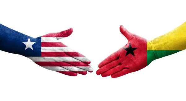 手に描かれたギニアビサウとリベリアの国旗との握手 孤立した透明なイメージ — ストック写真