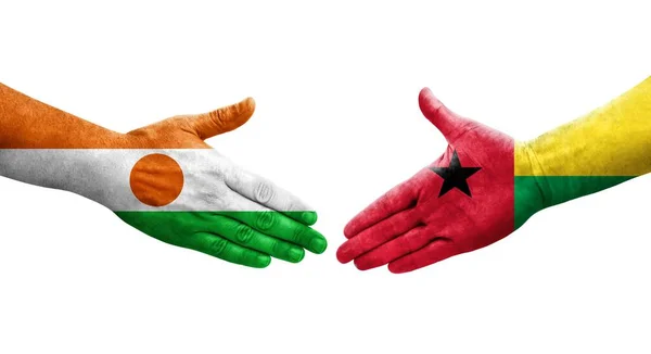 stock image Handshake between Guinea Bissau and Niger flags painted on hands, isolated transparent image.