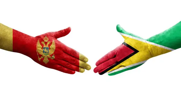 Stretta Mano Tra Guyana Montenegro Bandiere Dipinte Mani Immagine Isolata — Foto Stock