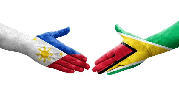 Handslag Mellan Guyana Och Filippinerna Flaggor Målade Händer Isolerad Transparent — Stockfoto