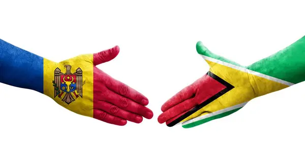 stock image Handshake between Guyana and Moldova flags painted on hands, isolated transparent image.