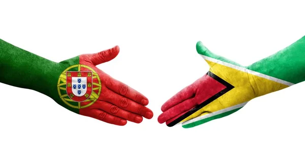 Händedruck Zwischen Flaggen Guyanas Und Portugals Auf Hände Gemalt Isoliertes — Stockfoto