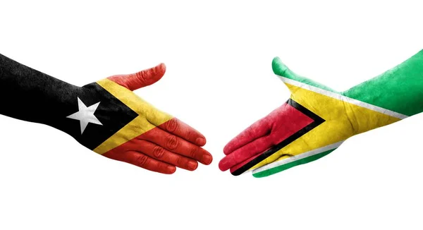 Guyana Timor Leste Bayrakları Arasındaki Sıkışma Ellerinde Izole Şeffaf Görüntü — Stok fotoğraf
