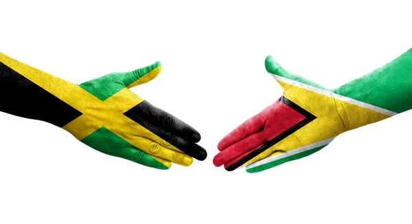 ガイアナとジャマイカの旗の間の握手手に描かれた孤立した透明なイメージ — ストック写真