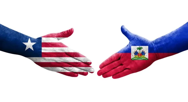 Händedruck Zwischen Haiti Und Liberia Flaggen Auf Hände Gemalt Isoliertes — Stockfoto