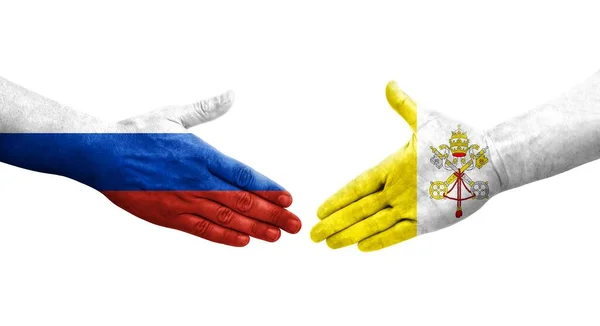 Stock image Handshake between Holy See and Russia flags painted on hands, isolated transparent image.