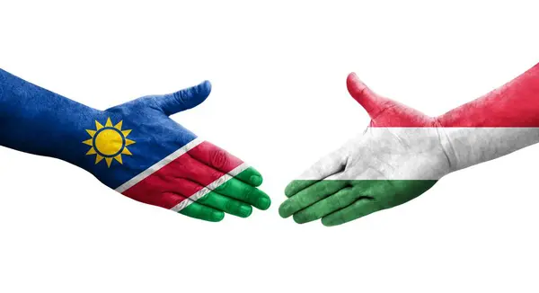 stock image Handshake between Hungary and Namibia flags painted on hands, isolated transparent image.