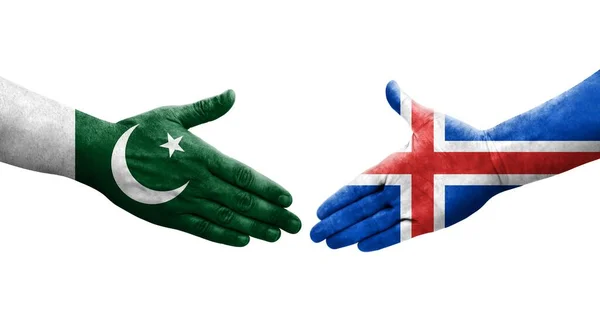 stock image Handshake between Iceland and Pakistan flags painted on hands, isolated transparent image.