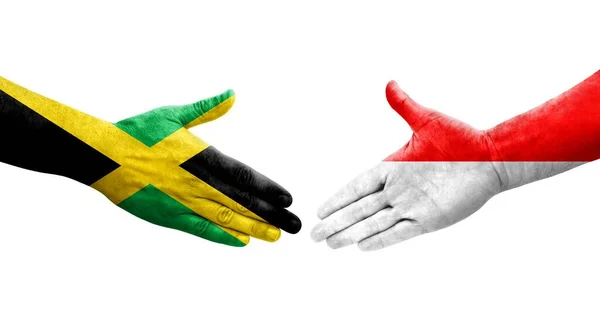 인도네시아와 자메이카의 국기가 손으로 그려지는 가운데 이미지를 악수를 — 스톡 사진