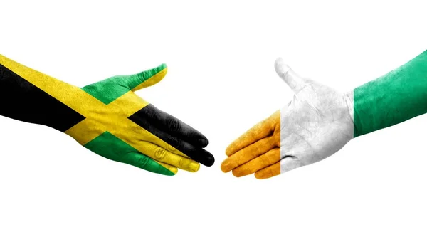 Handslag Mellan Elfenbenskusten Och Jamaica Flaggor Målade Händer Isolerad Transparent — Stockfoto