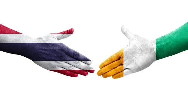 Händedruck Zwischen Der Elfenbeinküste Und Thailand Flaggen Auf Hände Gemalt — Stockfoto