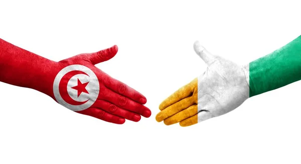 Uścisk Dłoni Między Wybrzeżem Kości Słoniowej Flagami Tunezji Namalowanymi Dłoniach — Zdjęcie stockowe