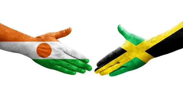 Apretón Manos Entre Jamaica Níger Banderas Pintadas Las Manos Imagen —  Fotos de Stock