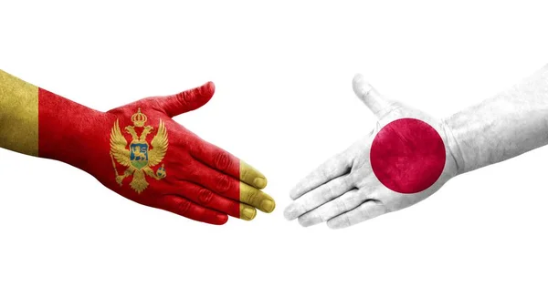 Handdruk Tussen Japan Montenegro Vlaggen Geschilderd Handen Geïsoleerd Transparant Beeld — Stockfoto