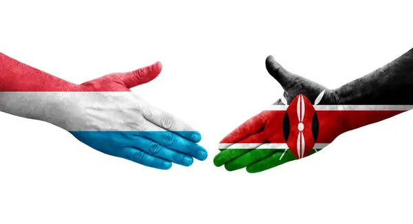 stock image Handshake between Kenya and Luxembourg flags painted on hands, isolated transparent image.