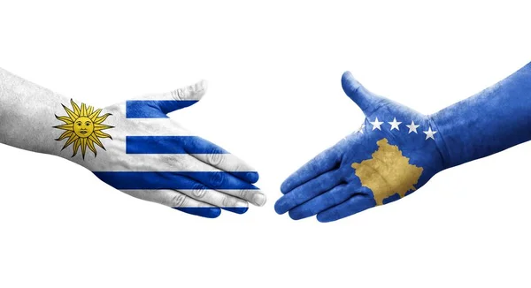 stock image Handshake between Kosovo and Uruguay flags painted on hands, isolated transparent image.