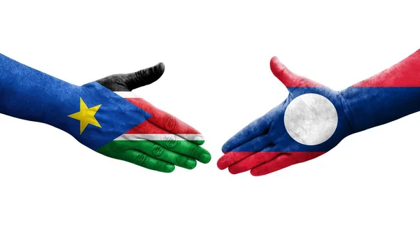 stock image Handshake between Laos and South Sudan flags painted on hands, isolated transparent image.