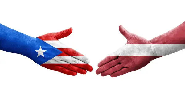 stock image Handshake between Latvia and Puerto Rico flags painted on hands, isolated transparent image.