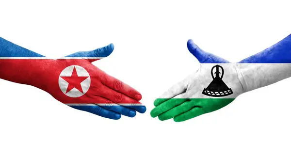 Aperto Mão Entre Lesoto Coreia Norte Bandeiras Pintadas Mãos Imagem — Fotografia de Stock