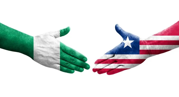 Handslag Mellan Liberia Och Nigeria Flaggor Målade Händer Isolerad Transparent — Stockfoto