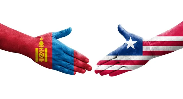 手に描かれたリベリアとモンゴルの旗の間の握手 孤立した透明なイメージ — ストック写真