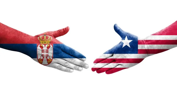 Händedruck Zwischen Liberianischen Und Serbischen Flaggen Auf Hände Gemaltes Isoliertes — Stockfoto