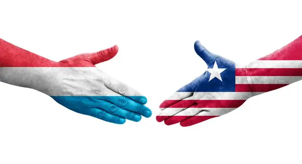 Händedruck Zwischen Liberianischen Und Luxemburgischen Flaggen Auf Hände Gemalt Isoliertes — Stockfoto