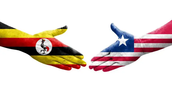 Händedruck Zwischen Flaggen Liberias Und Ugandas Auf Hände Gemalt Isoliertes — Stockfoto