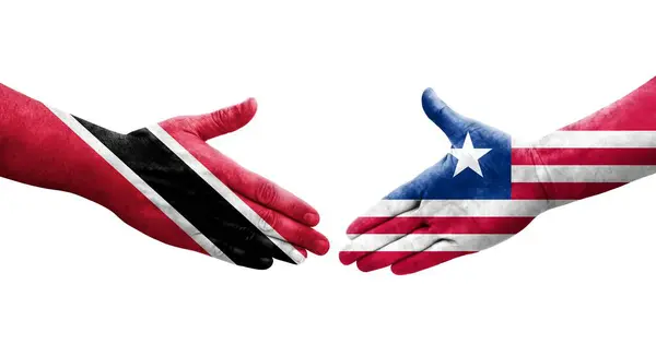 Händedruck Zwischen Liberia Und Trinidad Tobago Flaggen Auf Hände Gemalt — Stockfoto