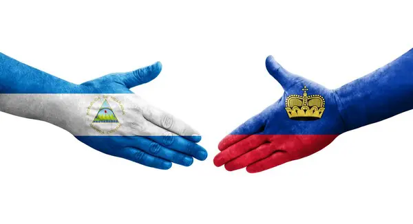 Mano Apretada Entre Las Banderas Liechtenstein Nicaragua Pintadas Las Manos — Foto de Stock