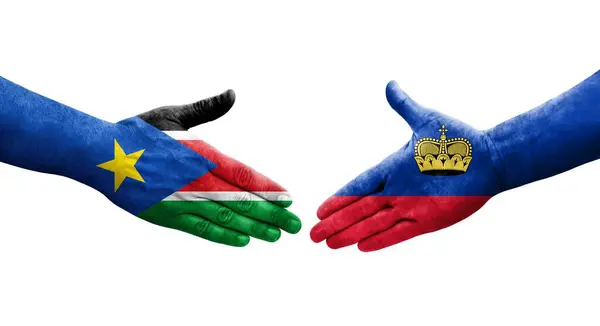 stock image Handshake between Liechtenstein and South Sudan flags painted on hands, isolated transparent image.