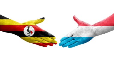 Lüksemburg ve Uganda bayrakları arasındaki el sıkışma, izole şeffaf görüntü.