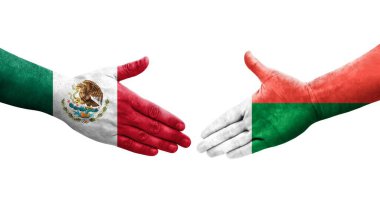 Madagaskar ve Meksika bayrakları arasındaki el sıkışma ellerinde resmedilmiş şeffaf bir görüntü..