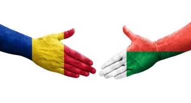 Madagaskar ve Romanya bayrakları arasındaki tokalaşma elleri boyalı, şeffaf görüntü izole.