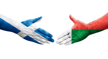 Madagaskar ve İskoçya bayrakları arasındaki el sıkışma, izole edilmiş şeffaf görüntü.