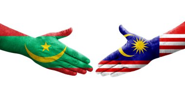 Malezya ve Moritanya bayrakları arasındaki el sıkışma ellerinde izole şeffaf görüntü.
