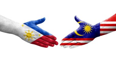 Malezya ve Filipinler arasındaki el sıkışma ellerinde boyanmış bayraklar, izole şeffaf görüntü.
