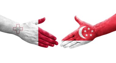 Ellere boyanmış Malta ve Singapur bayrakları arasındaki el sıkışma, izole şeffaf görüntü.