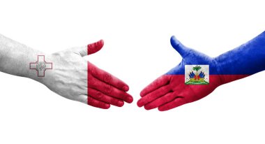 Malta ve Haiti bayrakları arasındaki el sıkışma, izole şeffaf görüntü.
